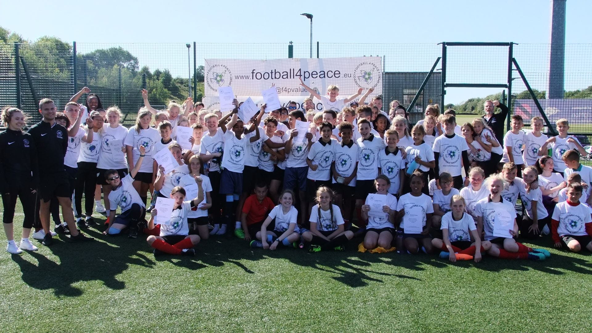 Group shot of the children on the football peace.